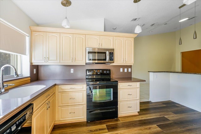 kitchen featuring sink, hanging light fixtures, dark hardwood / wood-style flooring, lofted ceiling, and black appliances