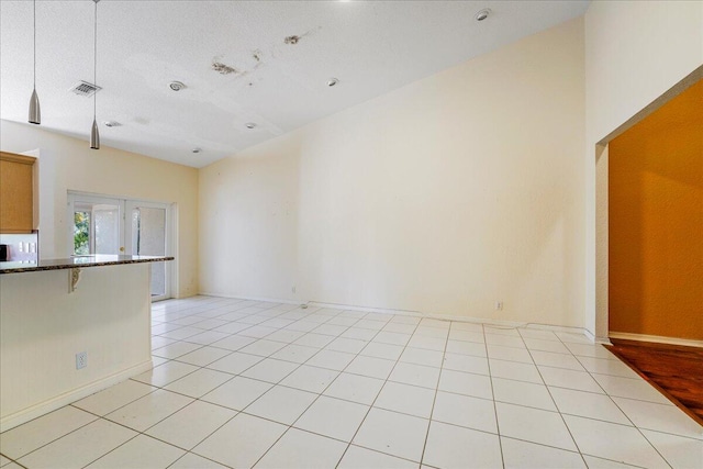 interior space featuring a textured ceiling and vaulted ceiling