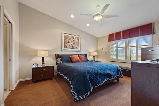 carpeted bedroom with vaulted ceiling and ceiling fan