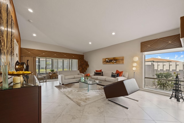 living room with lofted ceiling and light tile patterned floors