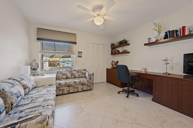 office space featuring light tile patterned floors, built in desk, and ceiling fan