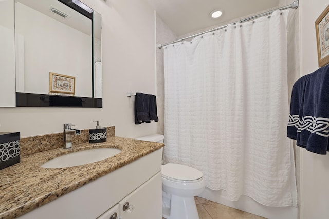 bathroom featuring toilet, vanity, and tile patterned flooring