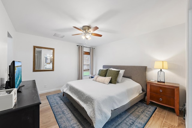 bedroom with ceiling fan and light wood-type flooring