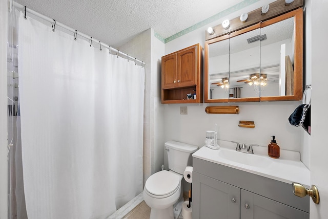 bathroom featuring vanity, toilet, and a textured ceiling