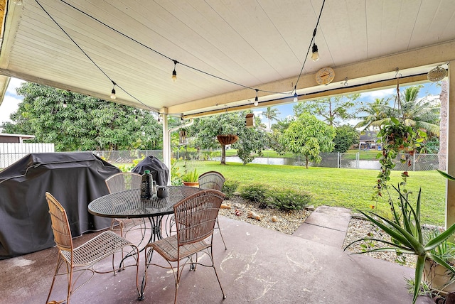 view of patio featuring a grill and a water view