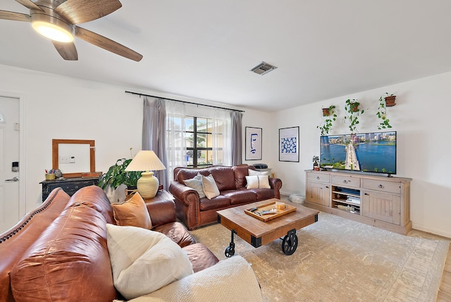 living room featuring ceiling fan and light hardwood / wood-style floors