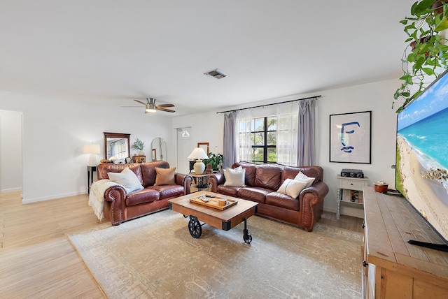 living room with ceiling fan and light hardwood / wood-style floors