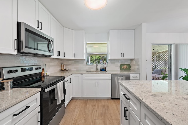 kitchen with white cabinetry, sink, plenty of natural light, and appliances with stainless steel finishes