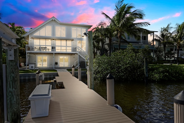 view of dock with a water view and a balcony