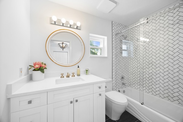 full bathroom with vanity, tiled shower / bath combo, and toilet