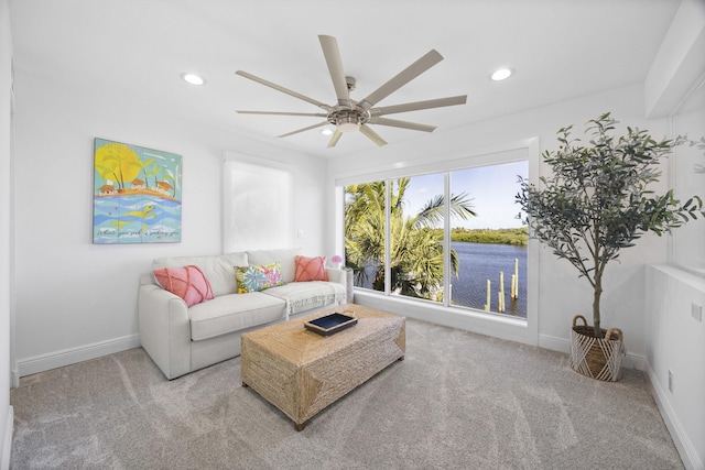 carpeted living room featuring ceiling fan