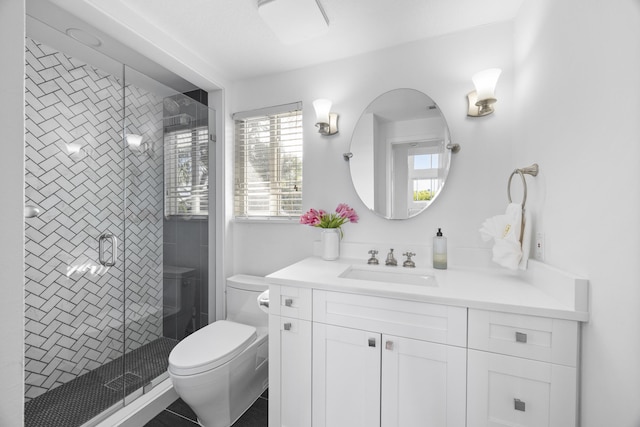 bathroom featuring vanity, toilet, and walk in shower