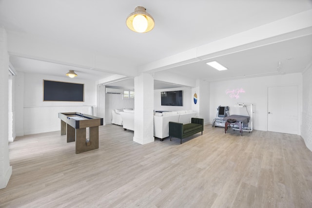 game room featuring light hardwood / wood-style flooring and a wall mounted AC