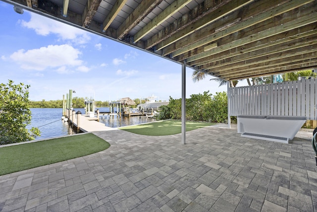 view of patio with a water view and a boat dock