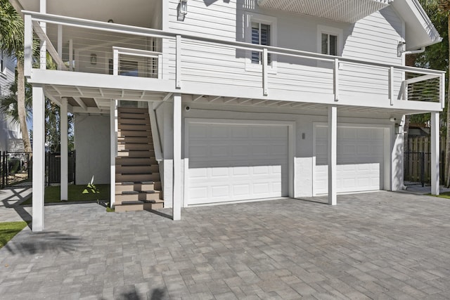 view of front of property featuring a balcony and a garage