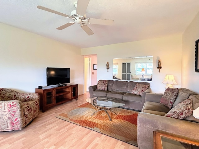 living room with hardwood / wood-style flooring and ceiling fan