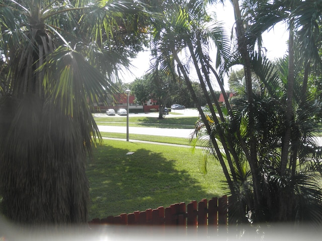 view of property's community featuring a lawn and a water view