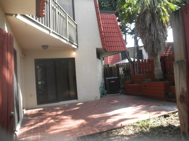 view of patio / terrace with central air condition unit and a balcony