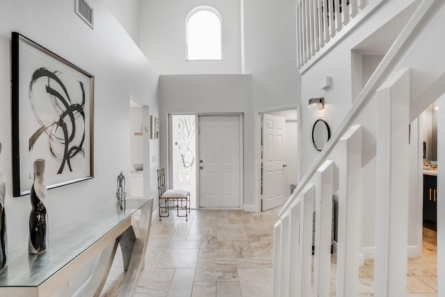 entryway with a towering ceiling