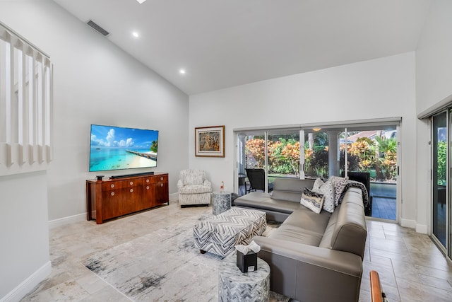 living room featuring plenty of natural light and high vaulted ceiling