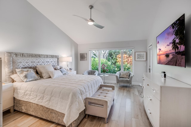 bedroom with ceiling fan, lofted ceiling, and light hardwood / wood-style flooring