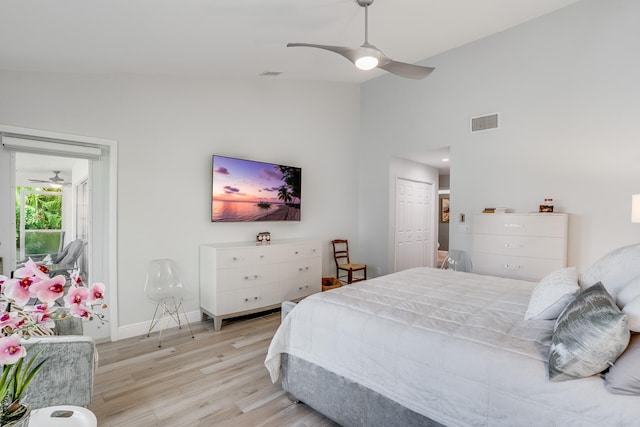 bedroom featuring ceiling fan, a closet, vaulted ceiling, and light wood-type flooring