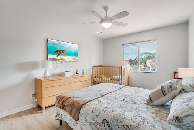 bedroom with light hardwood / wood-style flooring and ceiling fan