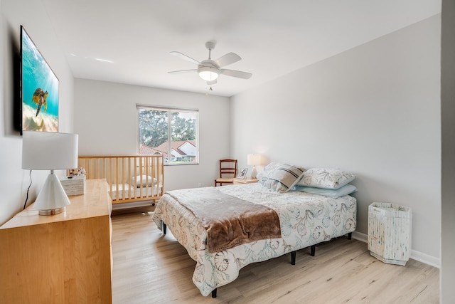 bedroom featuring ceiling fan and light hardwood / wood-style flooring