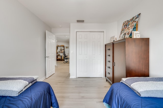 bedroom with a closet and light wood-type flooring