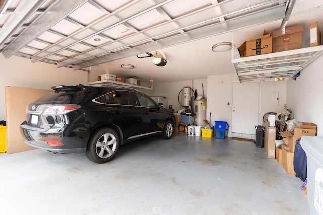 garage featuring electric water heater and a garage door opener