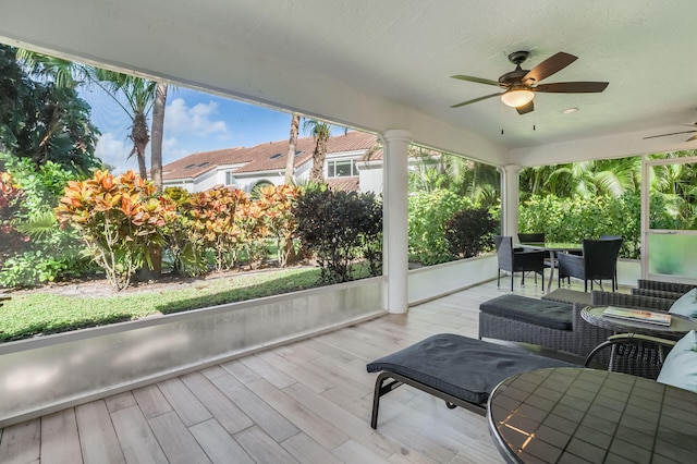 sunroom / solarium featuring ceiling fan