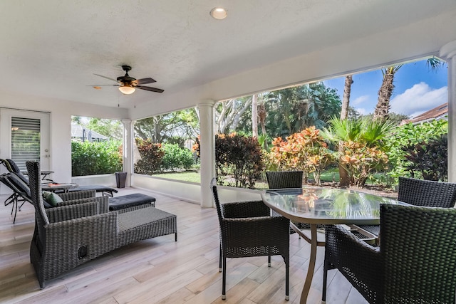 sunroom / solarium featuring decorative columns and ceiling fan