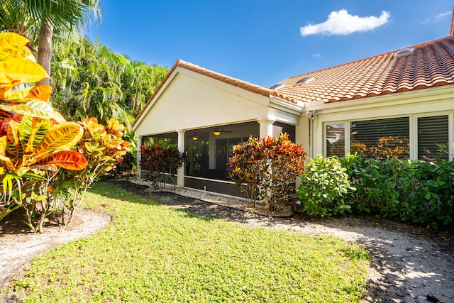 exterior space with a sunroom and a yard