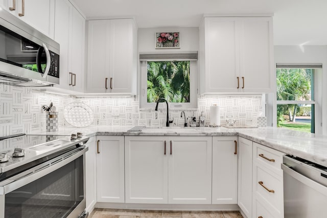 kitchen with white cabinetry and appliances with stainless steel finishes