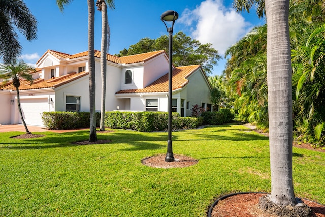 view of front of home featuring a garage and a front lawn