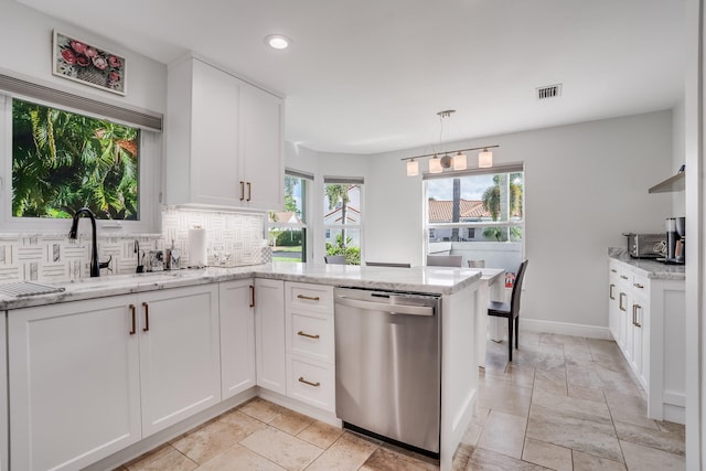 kitchen featuring dishwasher and white cabinets