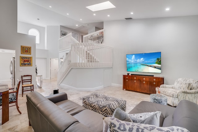 living room with high vaulted ceiling