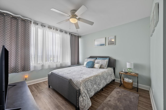 bedroom with ceiling fan and dark wood-type flooring