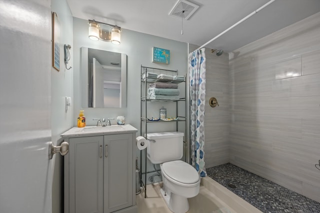 bathroom featuring curtained shower, vanity, and toilet