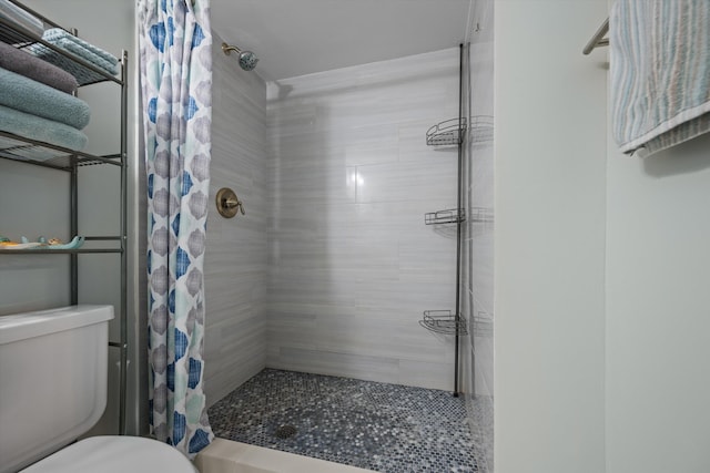 bathroom with a shower with curtain and toilet