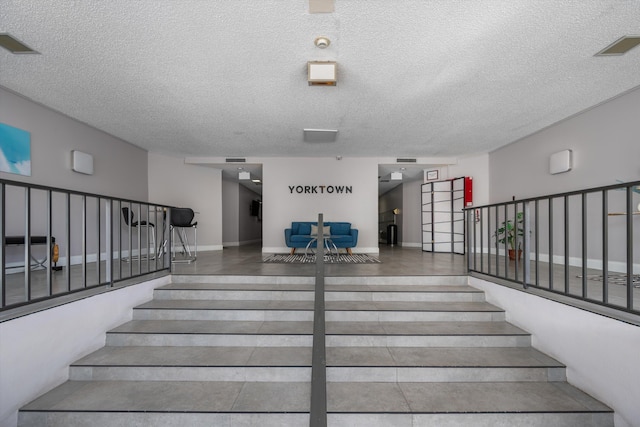 stairs with a textured ceiling