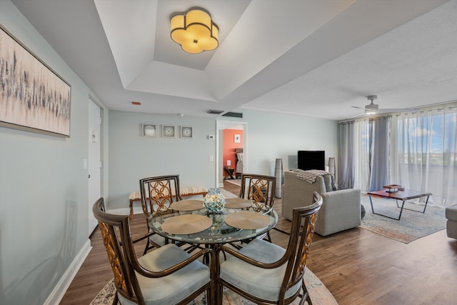 dining area featuring ceiling fan and dark wood-type flooring