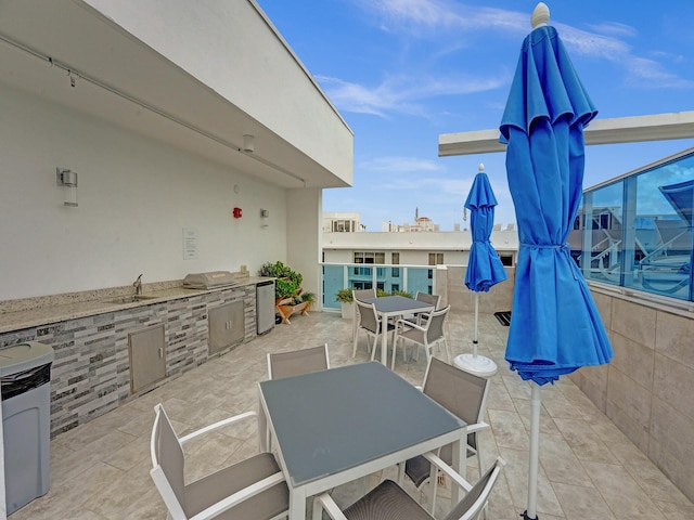 view of patio / terrace featuring area for grilling, sink, and grilling area