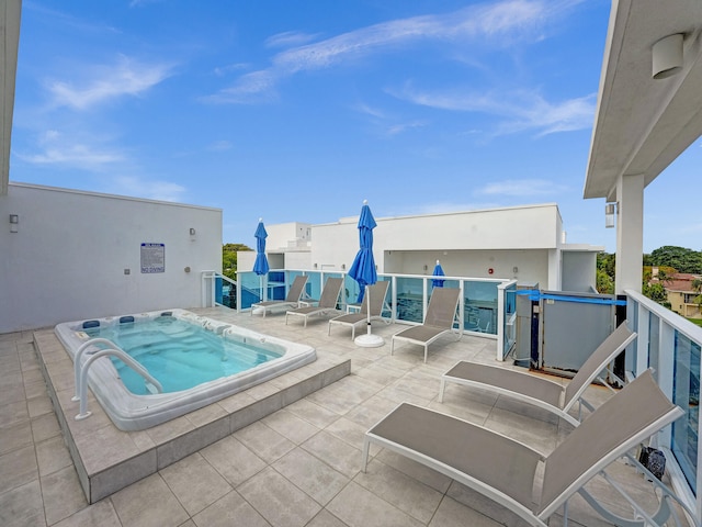 view of pool with an in ground hot tub