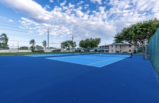 view of tennis court featuring basketball court