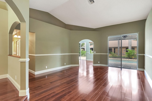 unfurnished room with hardwood / wood-style floors and lofted ceiling