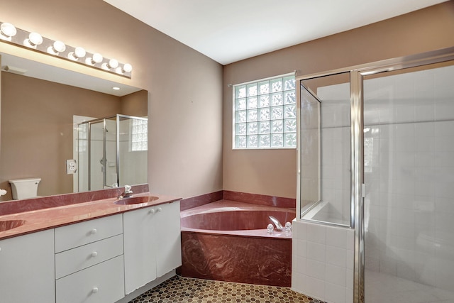 full bathroom featuring toilet, vanity, tile patterned floors, and plus walk in shower