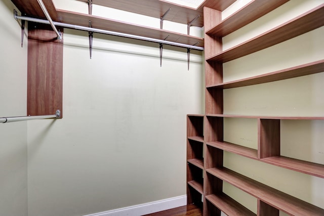 walk in closet featuring dark wood-type flooring