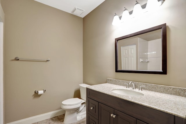 bathroom featuring toilet, vanity, and tile patterned floors