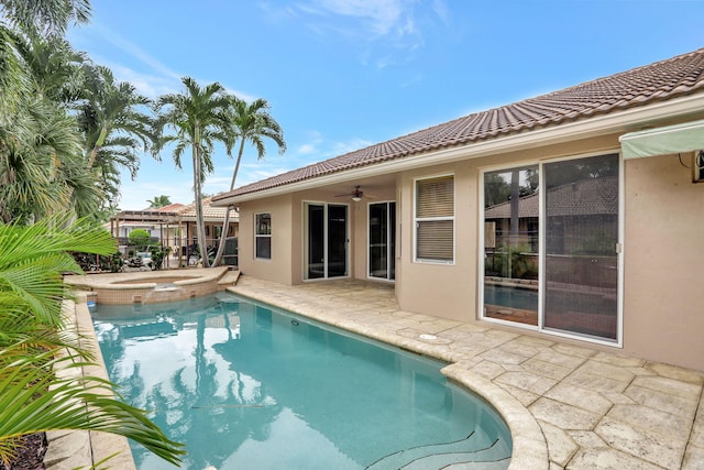 view of pool with a patio, ceiling fan, and an in ground hot tub